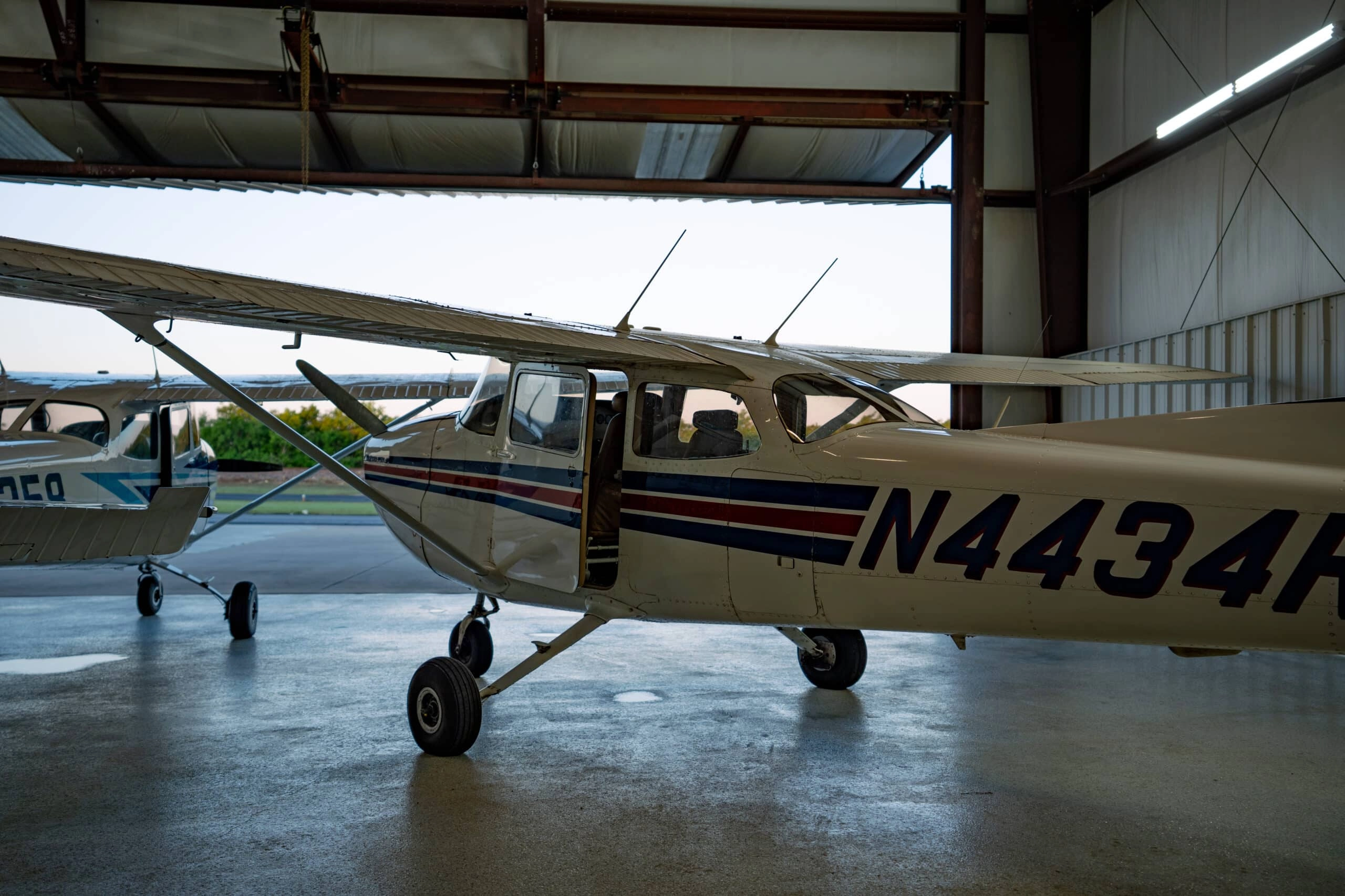 Bird Dog flight training aircraft parked in Fort Worth hangar